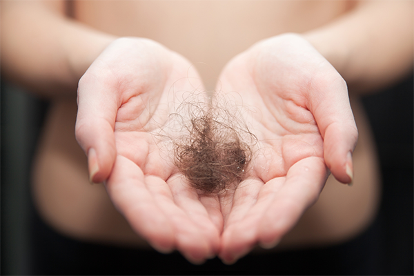 Ball of hair in persons hands